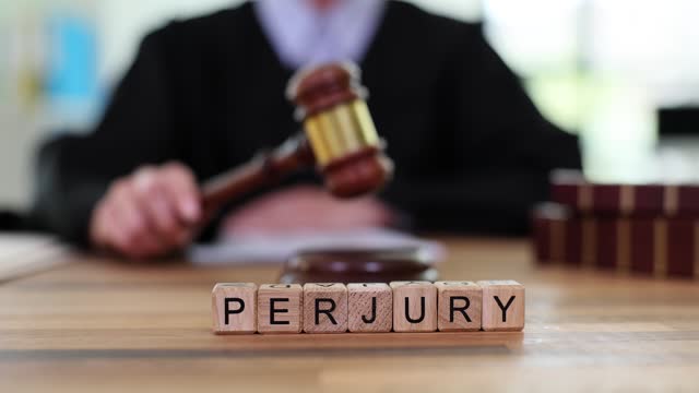 Word is perjury and judge bangs gavel in court