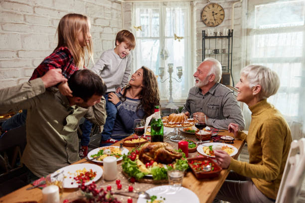 istock Happy extended family having fun during lunch in dining room. 1783401502