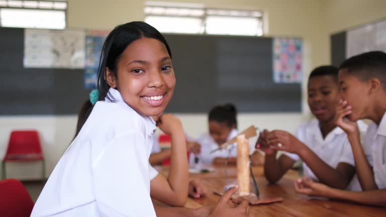 Portrait of a black schoolgirl laughing and smiling