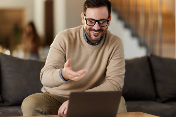 istock Happy man having a video call over laptop while working at home. 1783414206