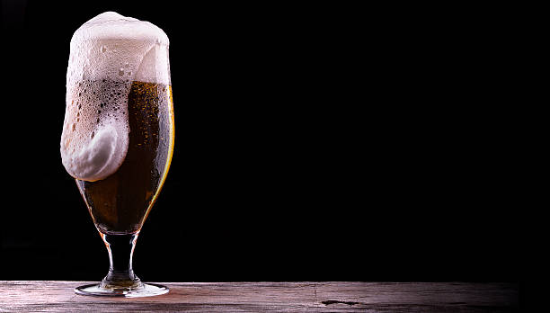 istock Frosty glass of light beer on black background 178341700