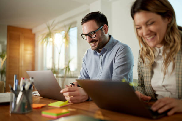 istock Happy business couple working on computers at home office. 1783422679