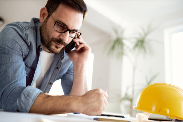 istock Male architect talking on mobile phone at home office. 1783429740