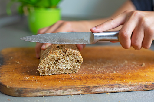 cut buckwheat bread on a cutting board in the kitchen