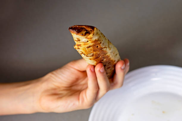 istock take banana pancakes from the plate with your hands 1783431441