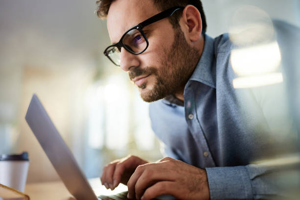 istock Young businessman typing an e-mail on laptop in the office. 1783433601