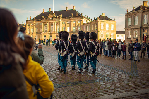 Copenhagen, Denmark - October 22, 2023: Royal guard from Amalienborg Palace parading through the streets of Copenhagen, Denmark, for the changing of the guard.