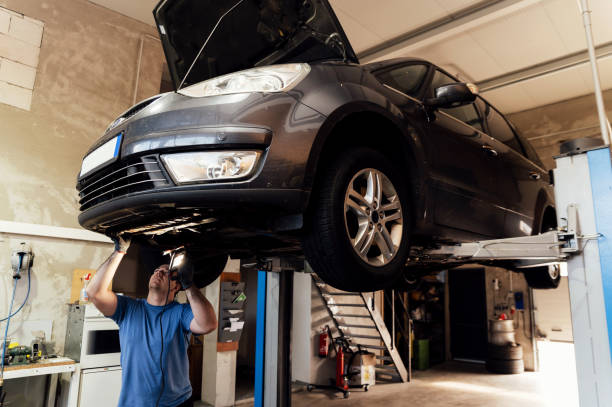 istock Professional auto mechanic working under a raised car in a car service. specialist examines the car. machine maintenance 1783474197