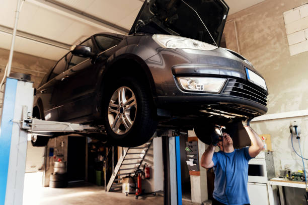 istock Professional auto mechanic working under a raised car in a car service. specialist examines the car. machine maintenance 1783474203