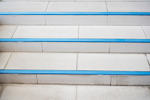 Picture of the stairs leading up and down next to the pool inside the house.