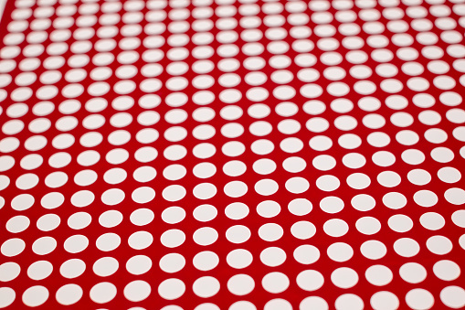 white dots on a red background, full frame