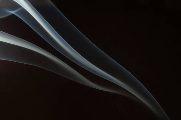 Swirling movement of white smoke on black background stock photo