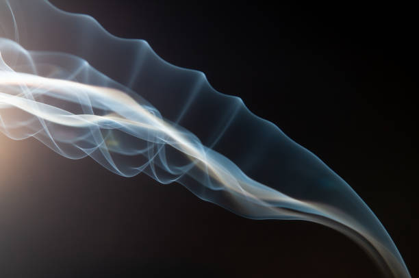 Swirling movement of white smoke on black background stock photo