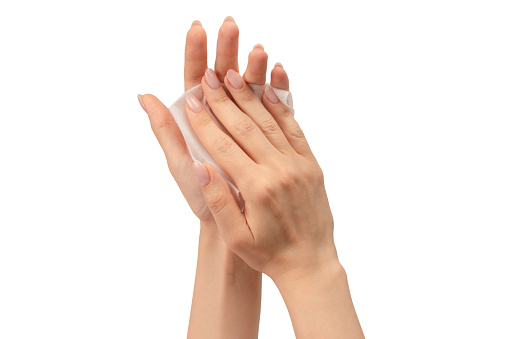 Wet wipe in a woman hand isolated on a white background. Washing hands isolated.