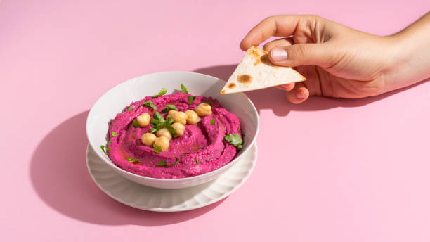 istock hand with pita bread and Beetroot hummus 1783529369