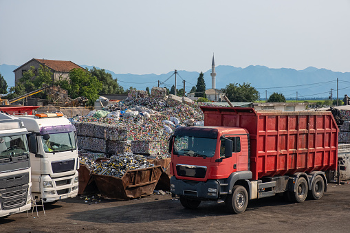 Dump trucks picking up scrap metal at recycling center in junk yard. Recycling industry. Environment and zero waste concept