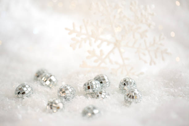 istock Christmas snowflake and small mirror balls on a white snow. Blurred background with beautiful bokeh. Shallow depth of field 1783541285