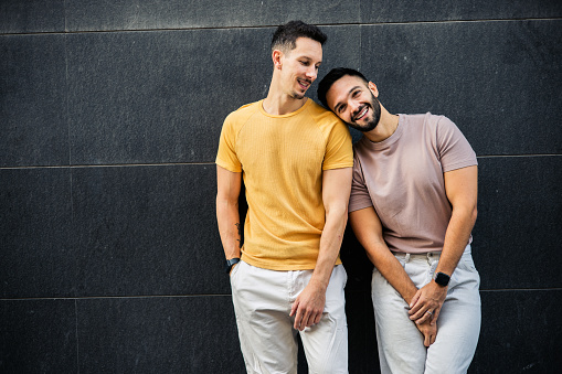 Portrait of a happy gay couple enjoying their vacation in Valencia.