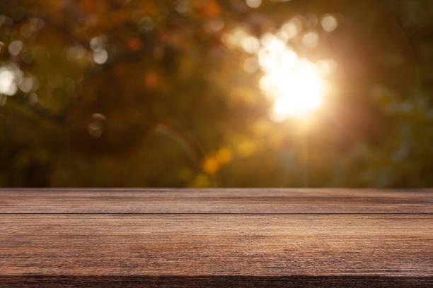 istock Wooden table on a natural blurred background 1783559523