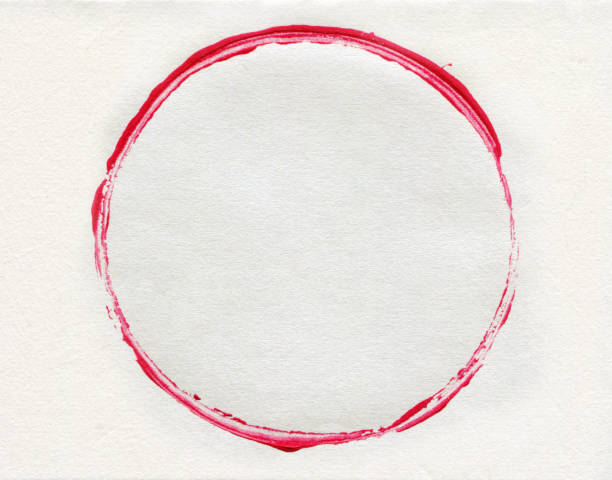 Red brush stroke circle frame with lipstick on white paper background.