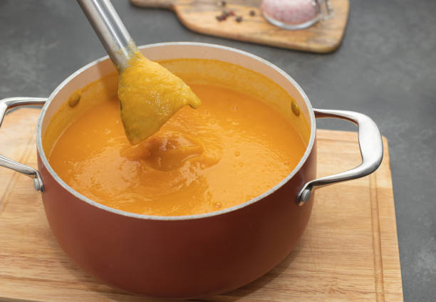 istock closeup of blender making pumpkin cream soup on dark kitchen counter 1783564013