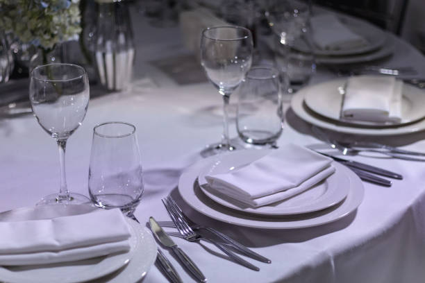 istock tableware Glasses, flower fork, knife served for dinner in restaurant with cozy interior 1783569601