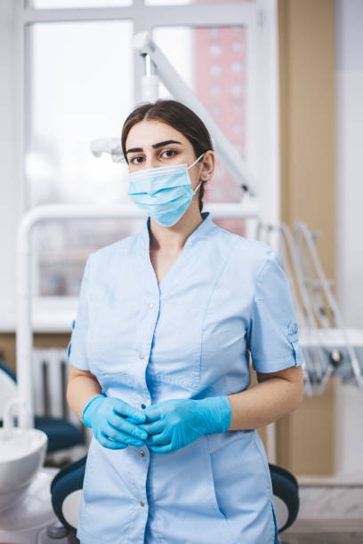 istock Professional young dentist posing in clinic office. 1783571979