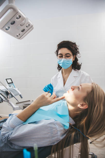 istock Female dentist examining patient's teeth on dentist chair 1783573919