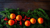 Christmas composition with tangerines and spruce branch