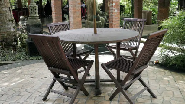 Wooden Chairs and table with circle table at Lembah Tumpang, Malang, East Java, Indonesia. January 17, 2023