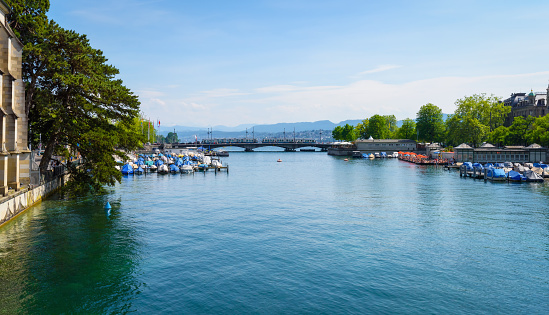 Lake Zurich in Switzerland. Boats at Limmat river. View from the city of Zurich on a clear sunny day. A walk through the city