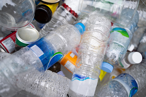 Plastic bottles in the recycling bin, waste management concept, stacked in bulk.