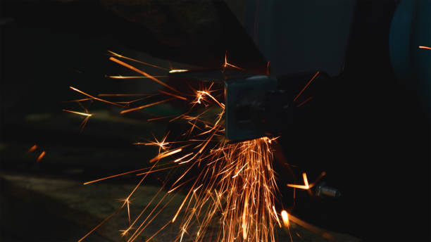 istock Man works grinder in workshop spitting out sparks 1783583479