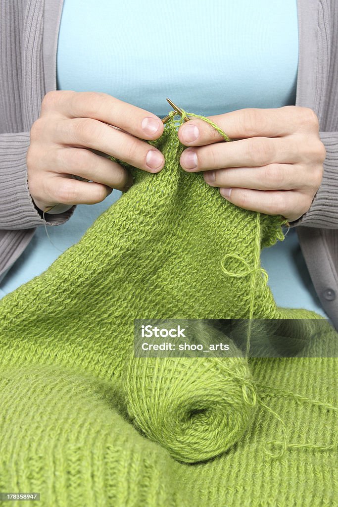 Primo piano di una donna di lavorazione a maglia filato verde - Foto stock royalty-free di Abbigliamento