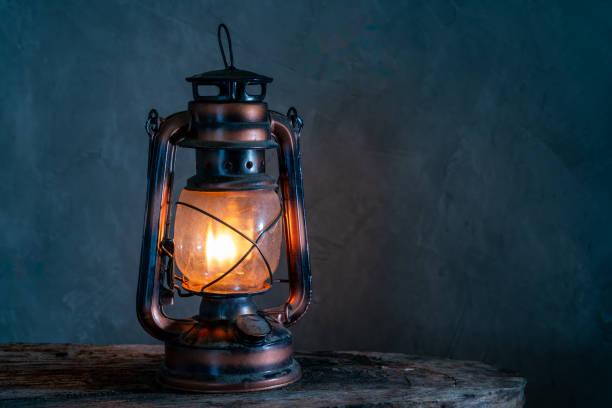 istock The old kerosene lamp on a wooden floor, old gray cement backdrop. 1783595519