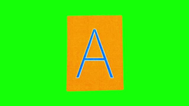 Capital letter A on orange sheet of paper which is unwrapped and then crumpled on green screen
