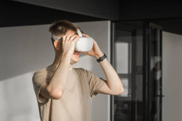 istock Man in vr headset exploring metaverse world, touching virtual reality subjects. Abstract cyber world in office 1783599159