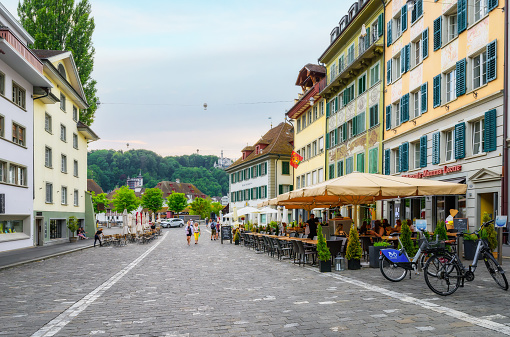 Lucerne, Switzerland - June 18, 2023: Street with colorful local style houses in Lucerne. A walk through the city.