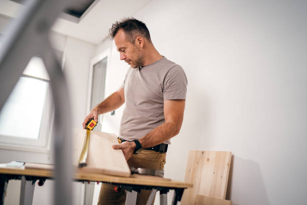 istock Professional carpenter at work measuring wooden planks 1783604796