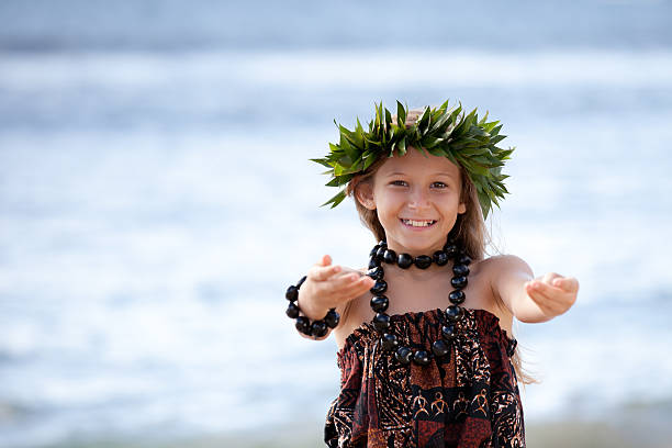 Pretty Girl smiling and dancing the Hula Pretty Hula Girl dancing at the beach wearing a handmade head piece hula dancing stock pictures, royalty-free photos & images