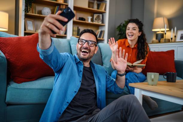 istock Couple with a smartphone having video call at home 1783607256