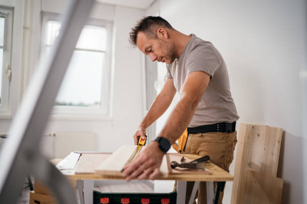 istock Professional carpenter at work measuring wooden planks 1783608984
