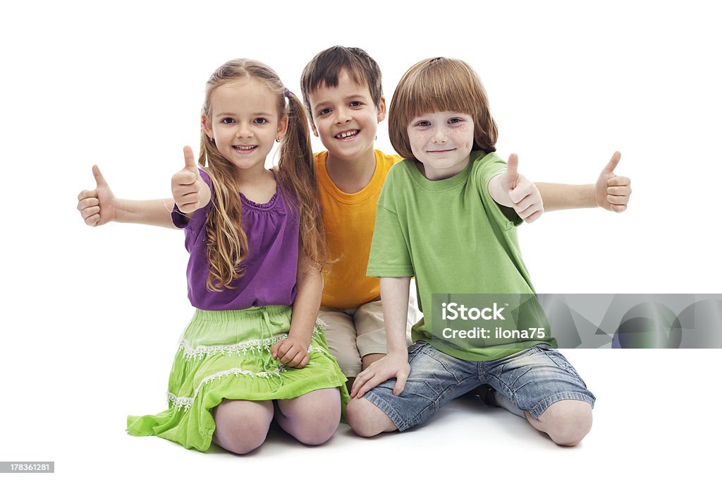 Three kids giving thumbs up sign Group of three kids giving thumbs up sign - isolated Child Stock Photo