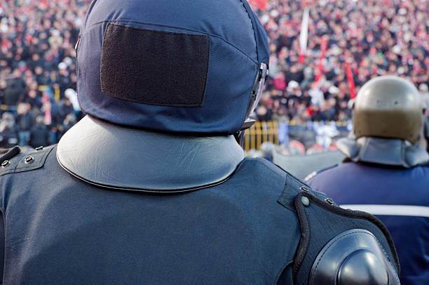 istock Back of policeman guarding fans 178362212