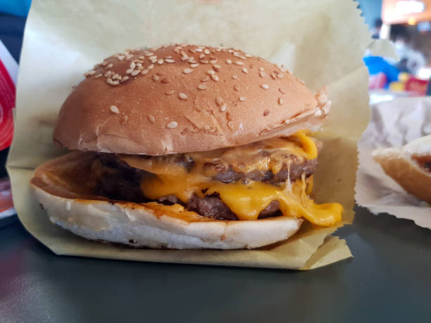 istock Close up view for meat cheese meat burger in it is paper 1783624426