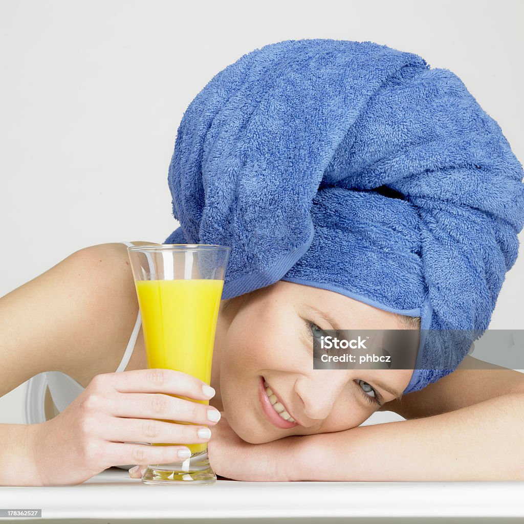 woman with glass of juice woman with turban and a glass of juice Adult Stock Photo