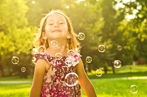 istock Little girl in park with bubbles 178362955