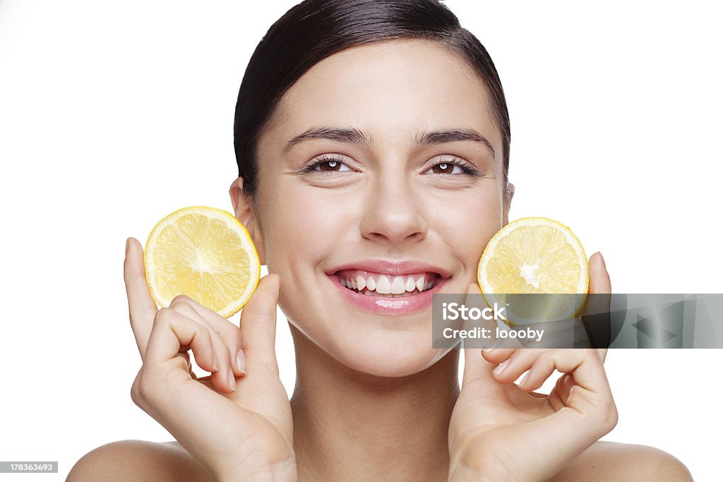 natural skin care "fresh faced young female holding lemon slices and smiling..Light retouching, skin texture intact!" Human Face Stock Photo