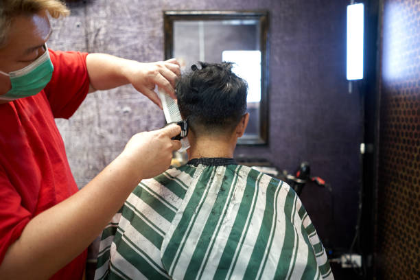 istock Back of a client sitting while having his hair cut in a barber shop 1783637850