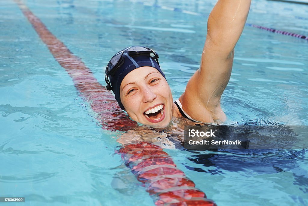 i won this competition! nice girl professional swimmer is happy she won swimming contest Cap - Hat Stock Photo